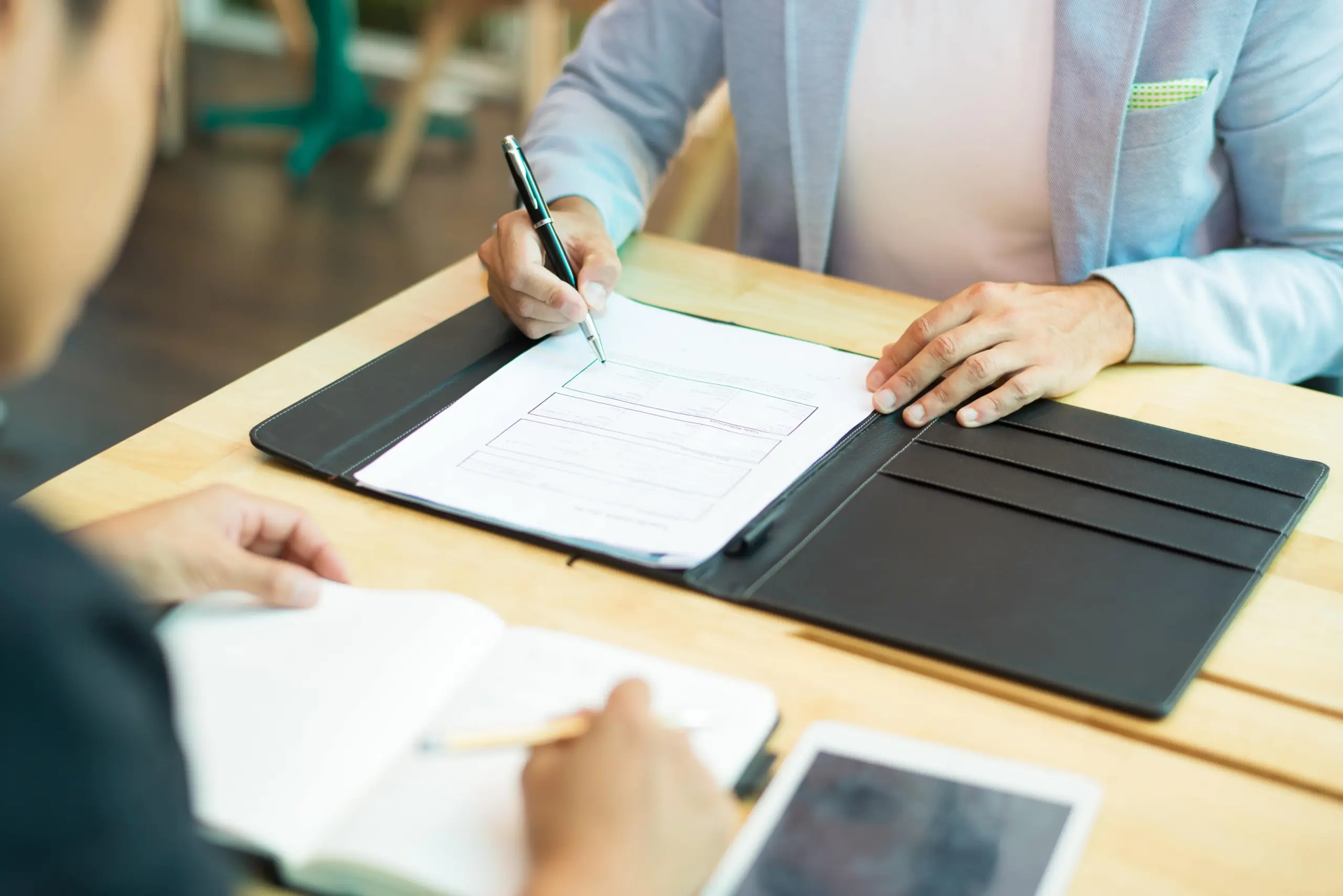 close up businessman sitting table filling document (1)