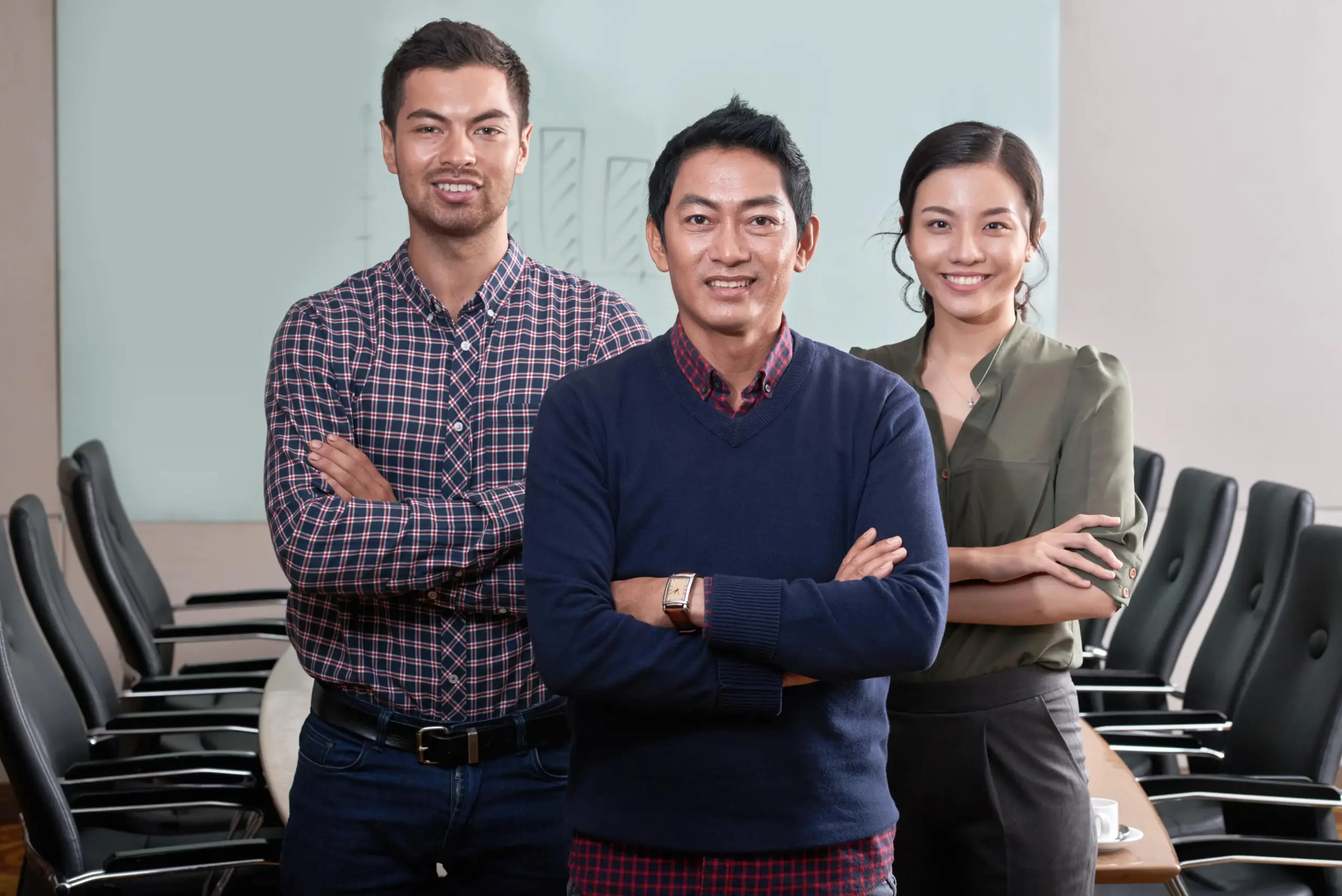 confident business team standing arms folded conference room (1)
