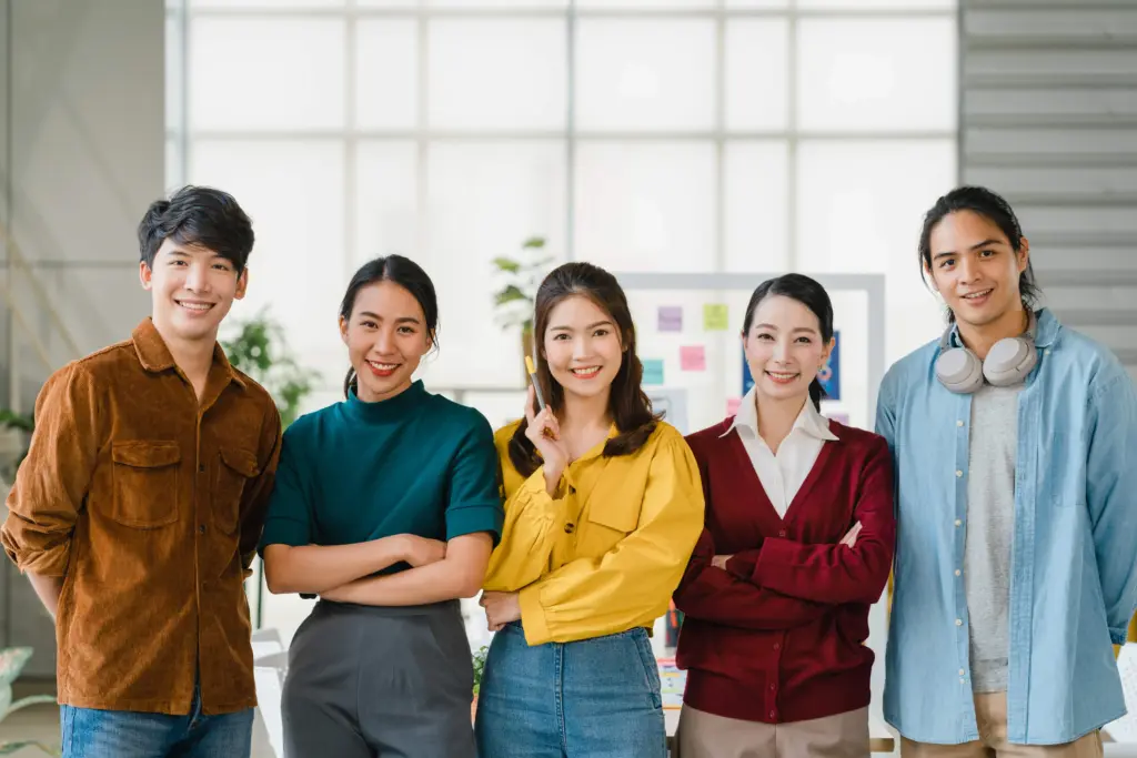 group asia young creative people smart casual wear smiling arms crossed creative office workplace diverse asian male female stand together startup coworker teamwork concept (1)