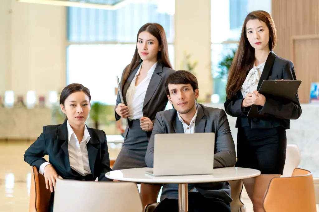 group smart business asian teamwork business uniform look camera with confident cheerful with modern design office background (1)