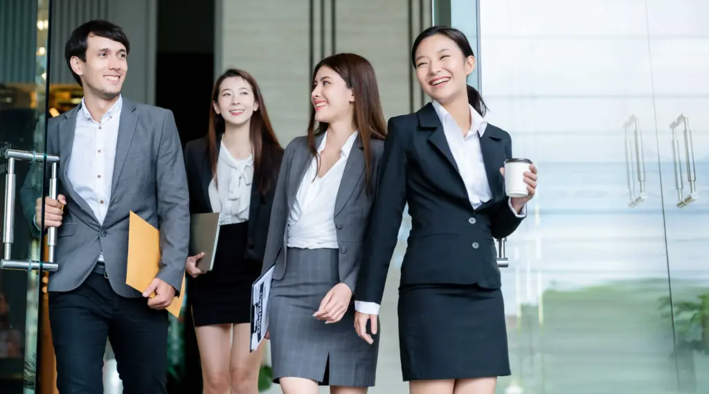 group smart young asian businessmale female formal dress walking pass modern office entrance with confident happiness (1) (1)