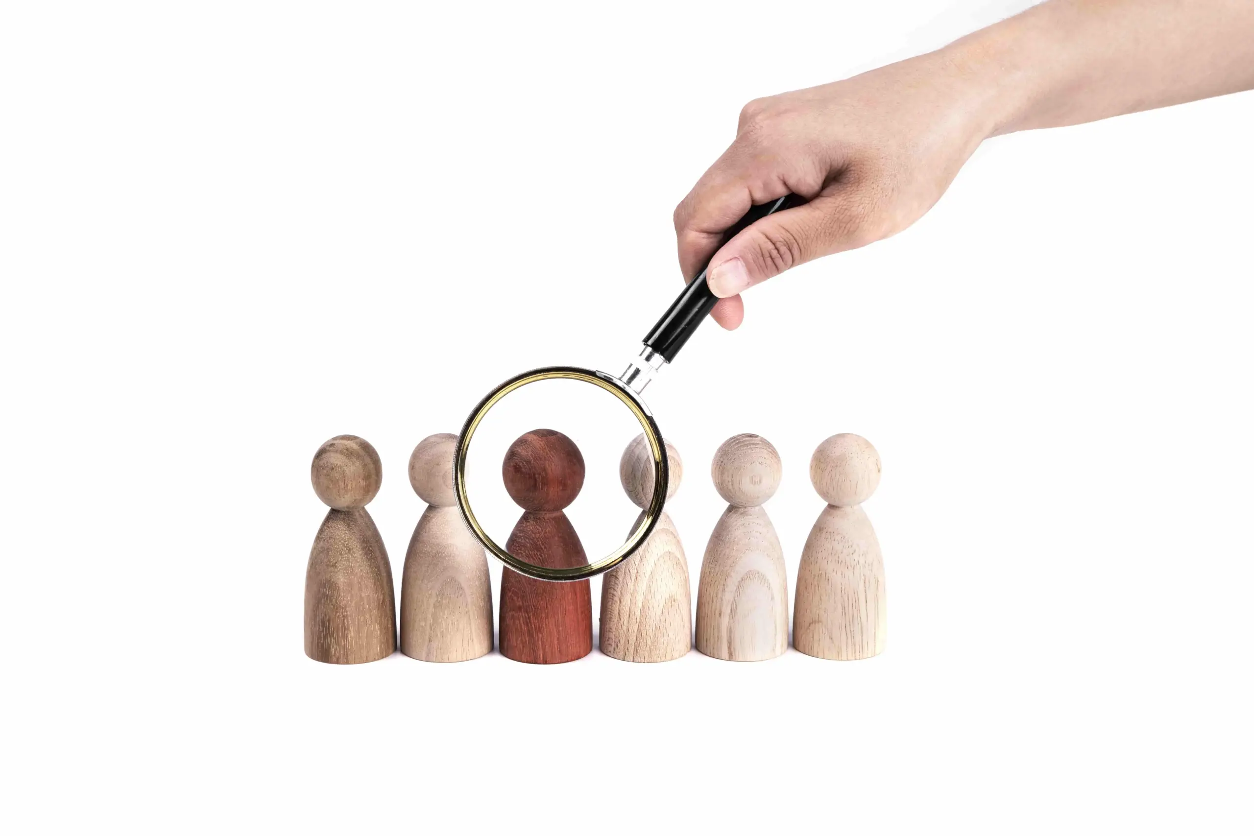 hand holding magnifying glass red figurine row (1)