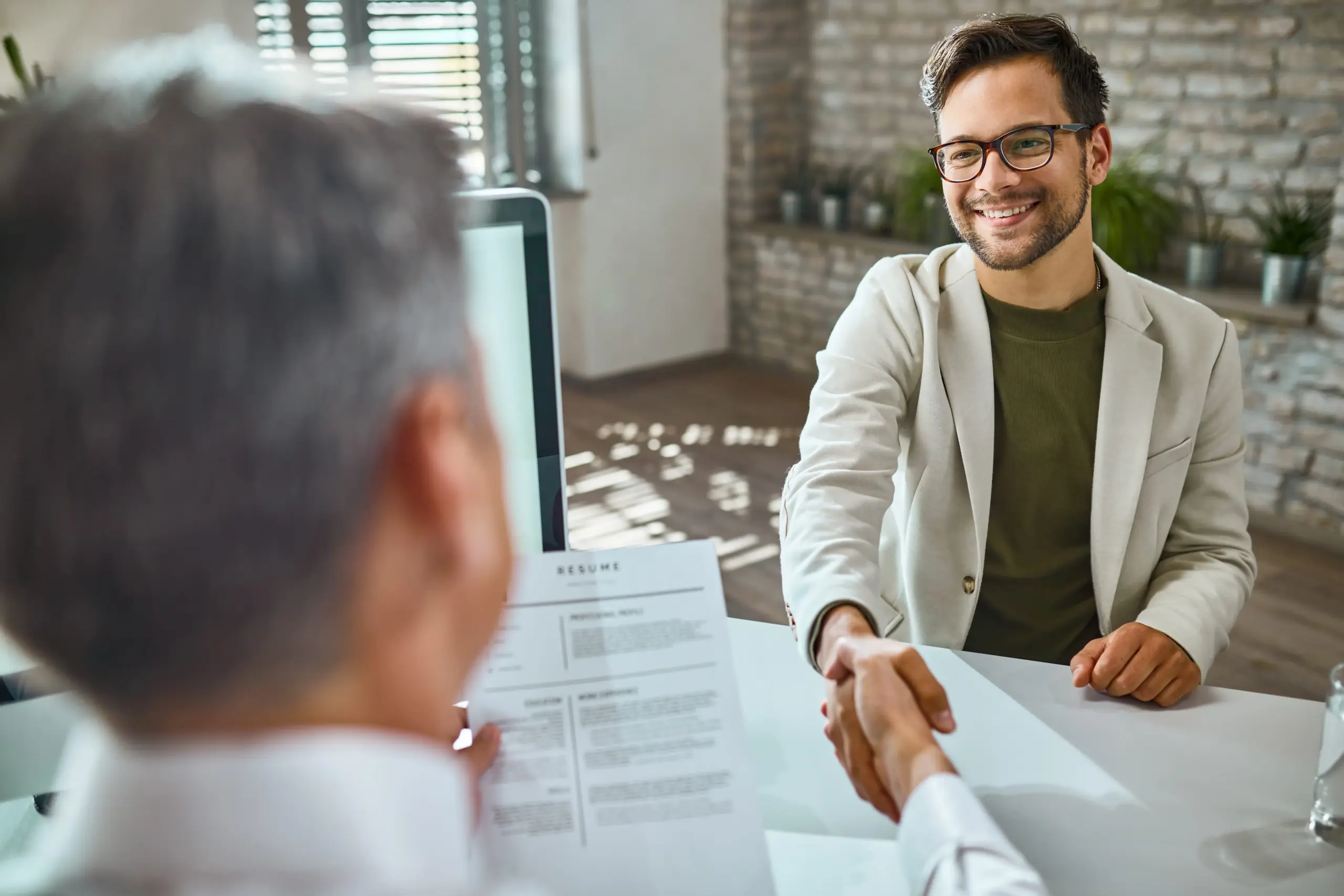 happy male candidate greeting member human resource team job interview office (1)