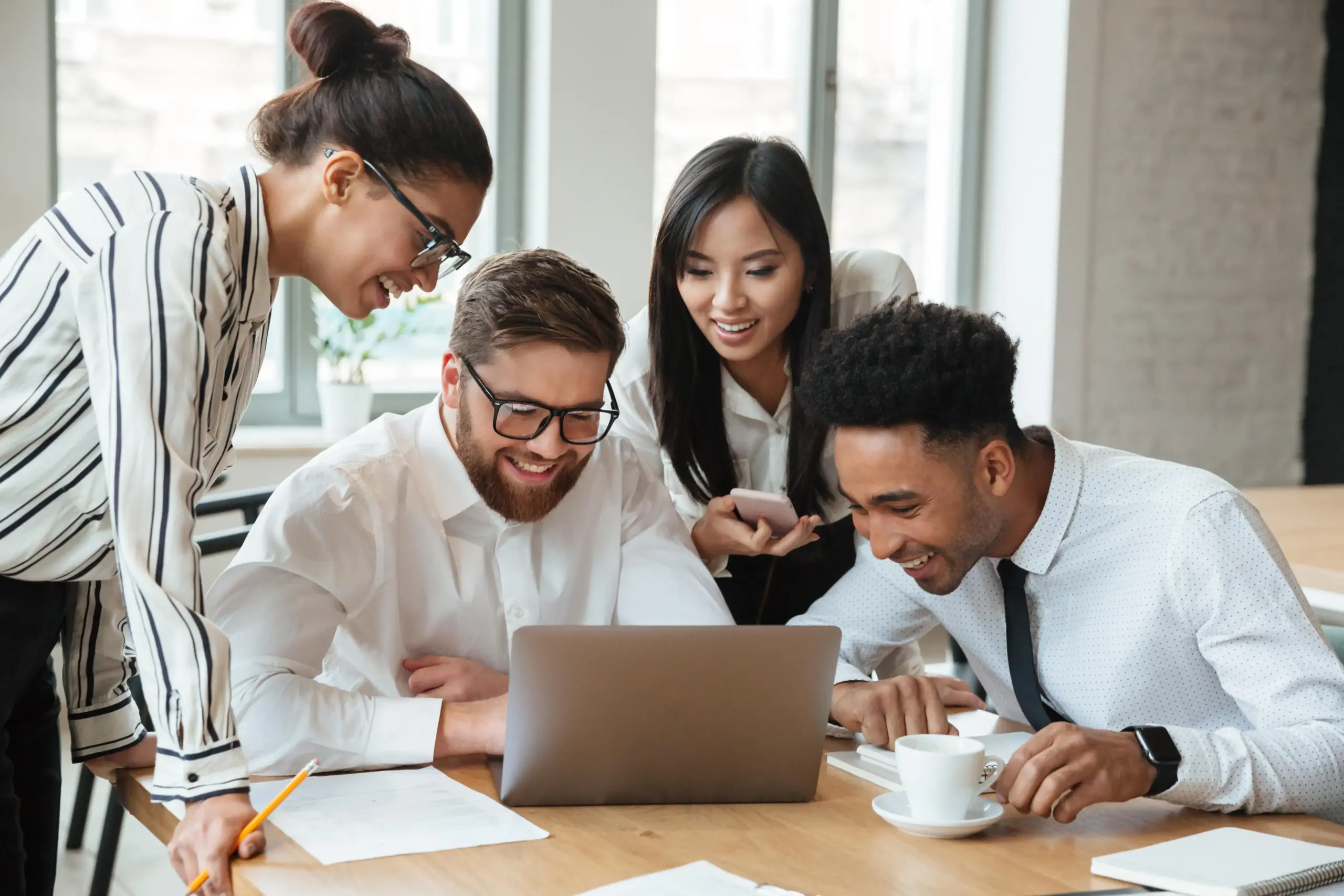 happy young business colleagues using laptop computer (1)