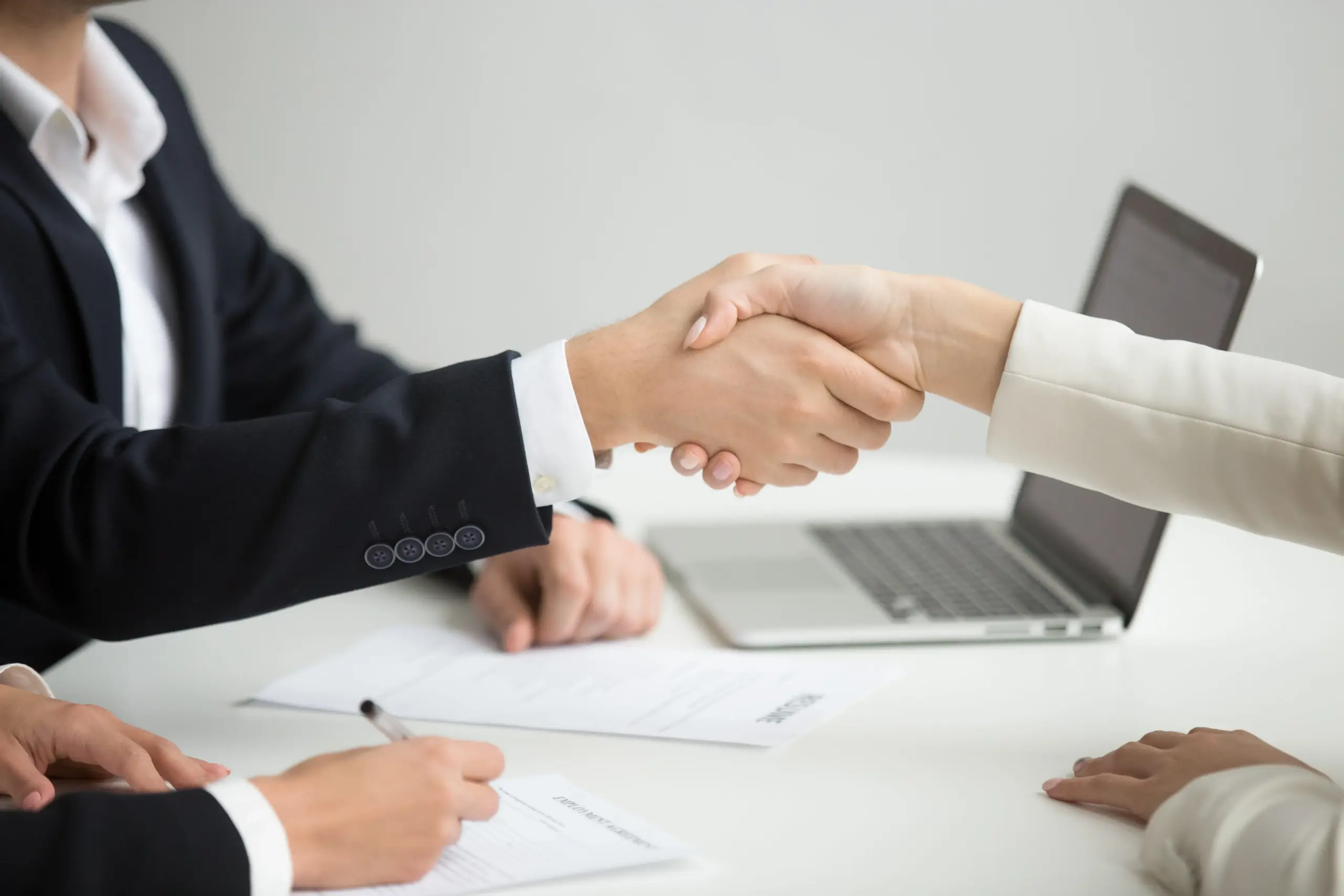 hr handshaking successful candidate getting hired new job closeup (1)