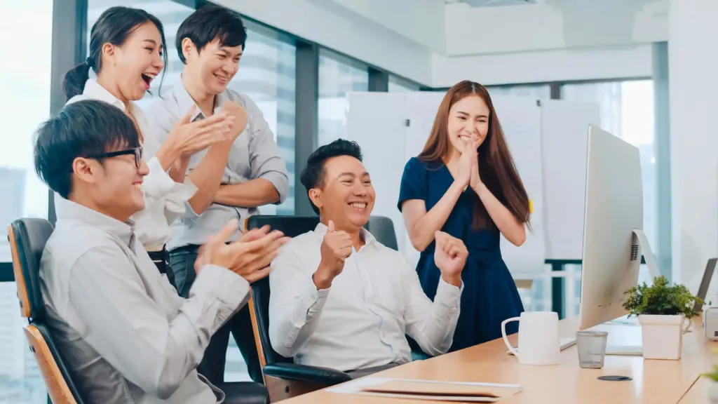millennial group young businesspeople asia businessman businesswoman celebrate giving five after dealing feeling happy signing contract agreement meeting room small modern office (3) (1)