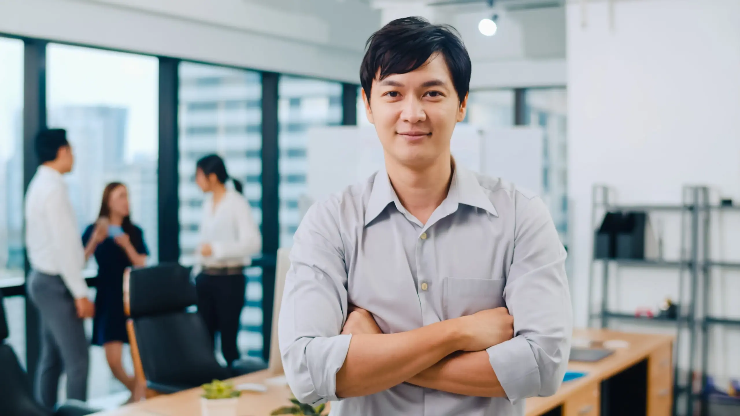 portrait successful handsome executive businessman smart casual wear looking camera smiling arms crossed modern office workplace young asia guy standing contemporary meeting room (1)