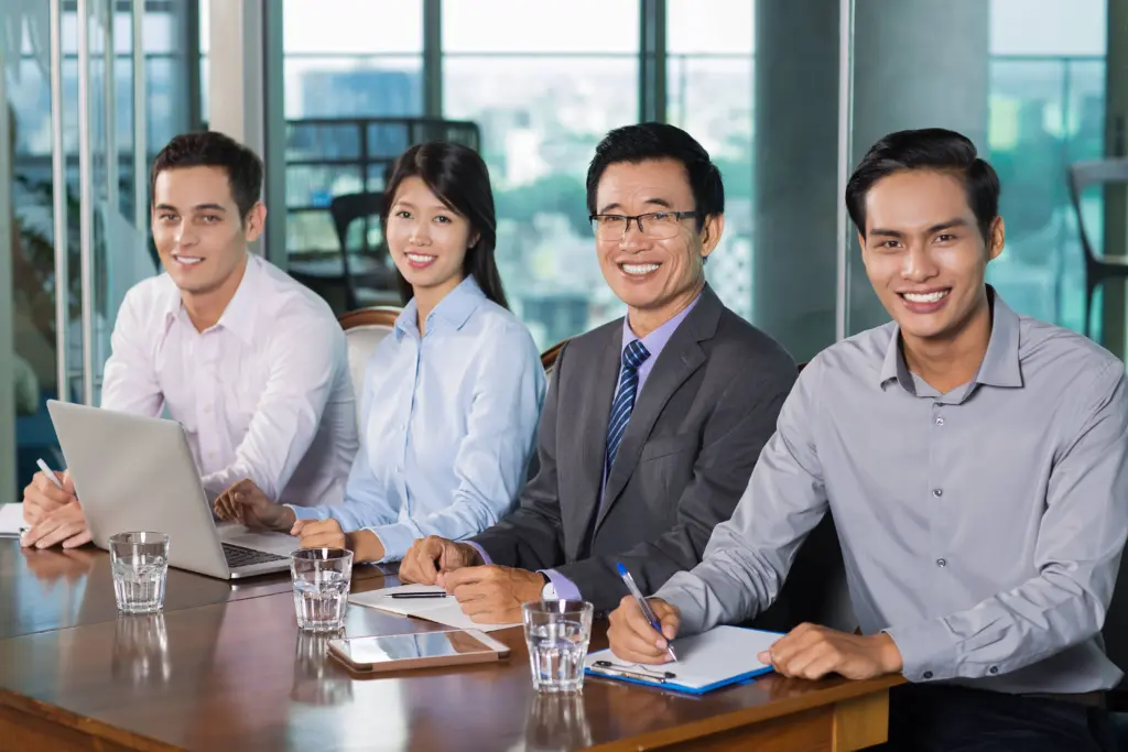 smiling business people holding meeting office (1)