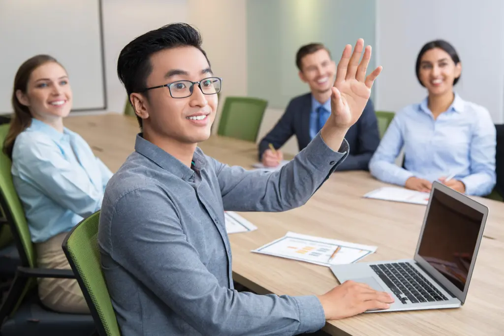 smiling businessman raising hand conference (1)