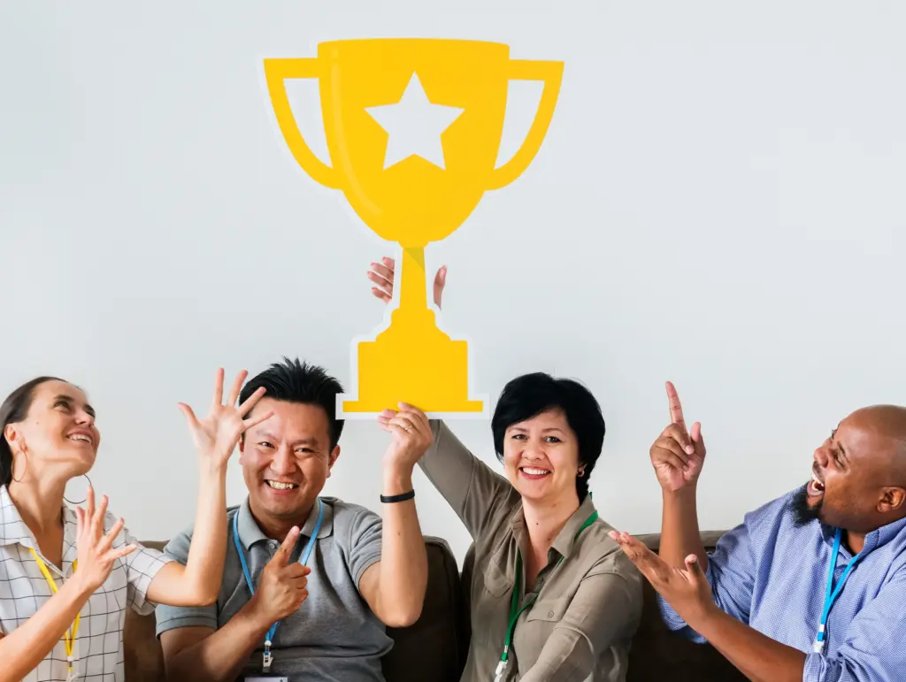 workers celebrating their success with trophy (1)
