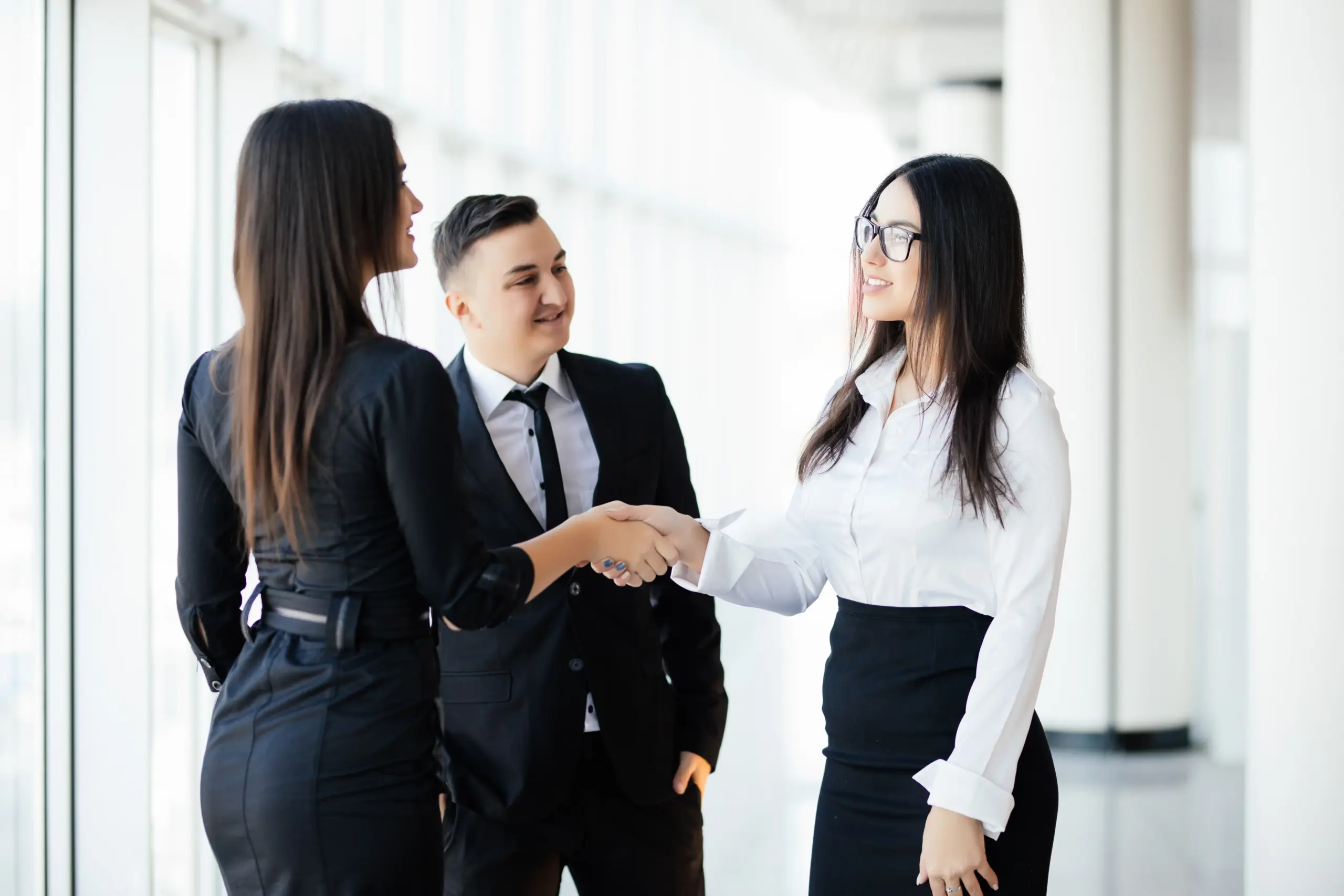 business partners shaking hands meeting hall two business woman greetings handshake office (1)