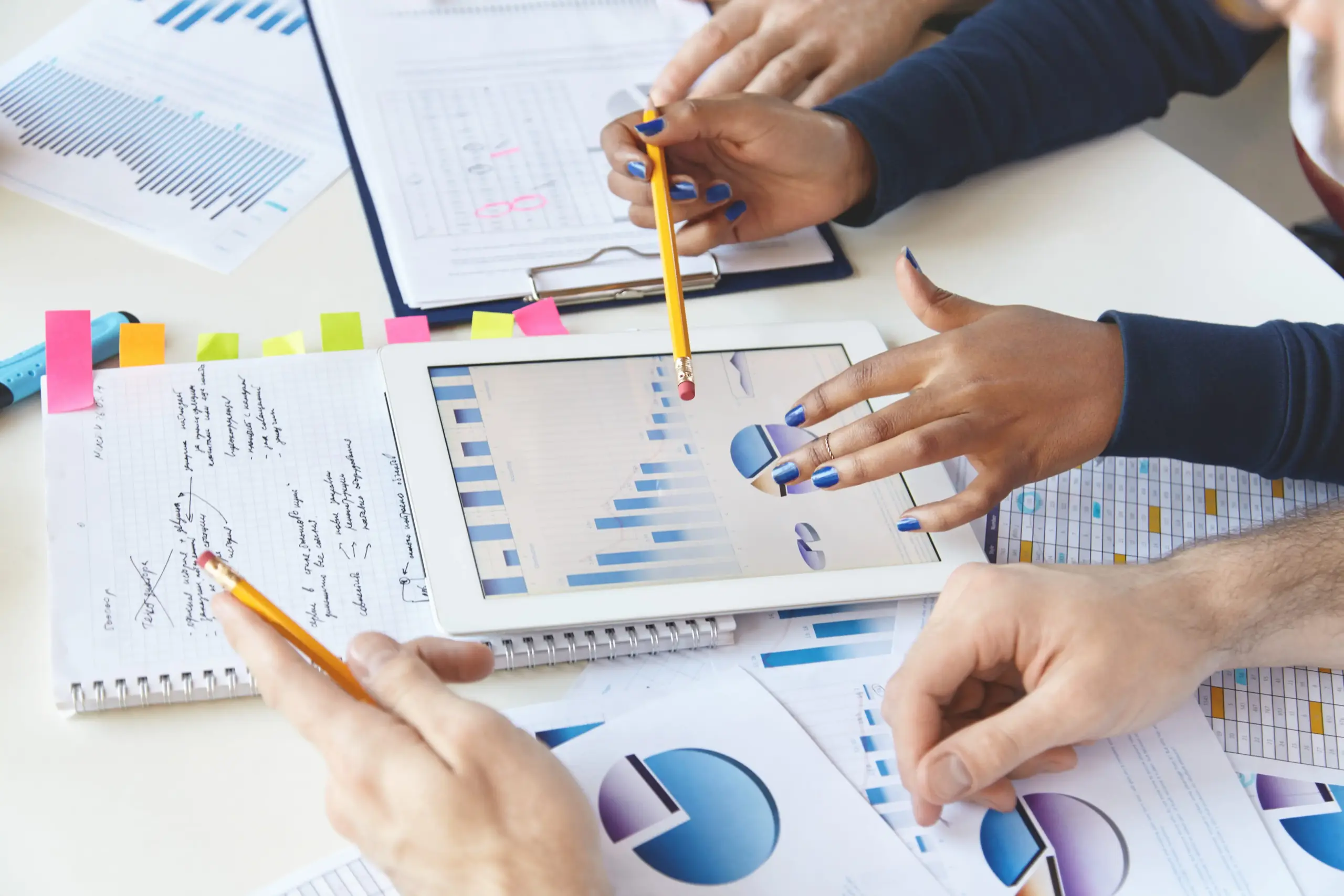 colleagues working together financial report using modern gadget (1)
