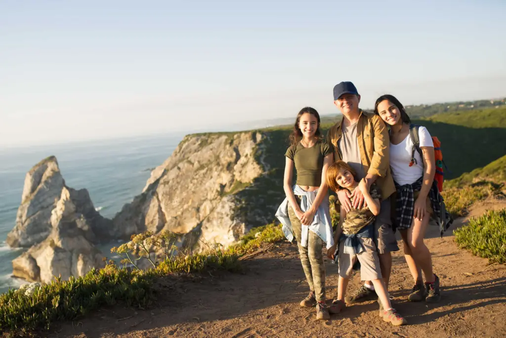 happy father hiking with children mountains (1)