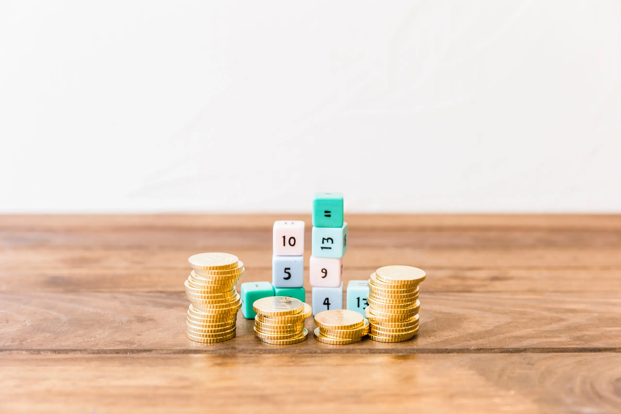 stacked coins math blocks wooden tabletop (1)