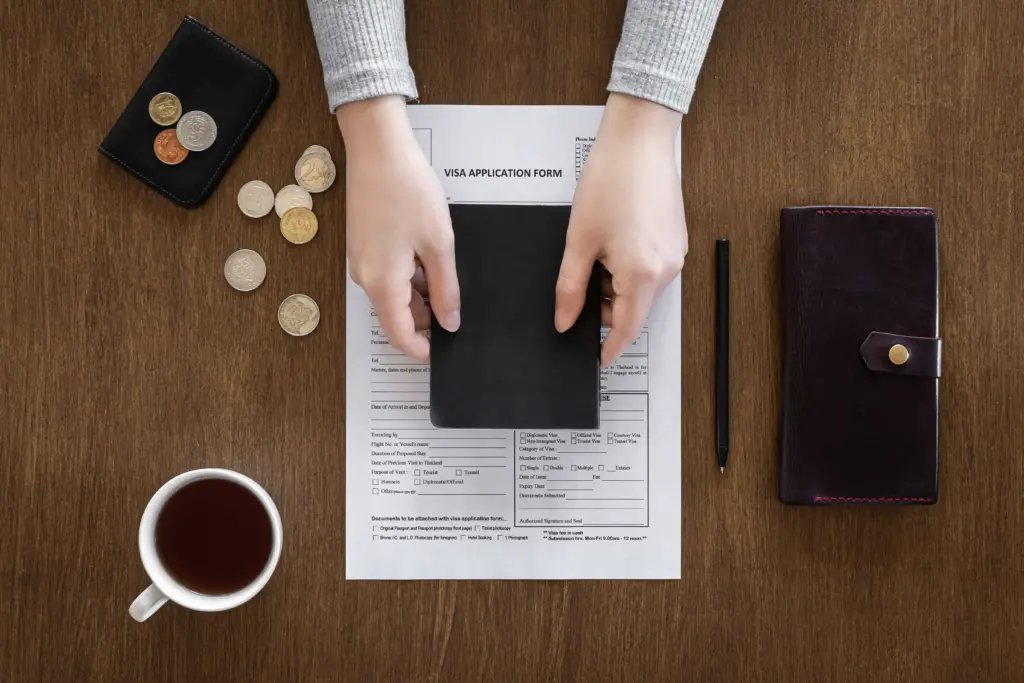 visa application form wooden table visa processing registration flat lay (1)