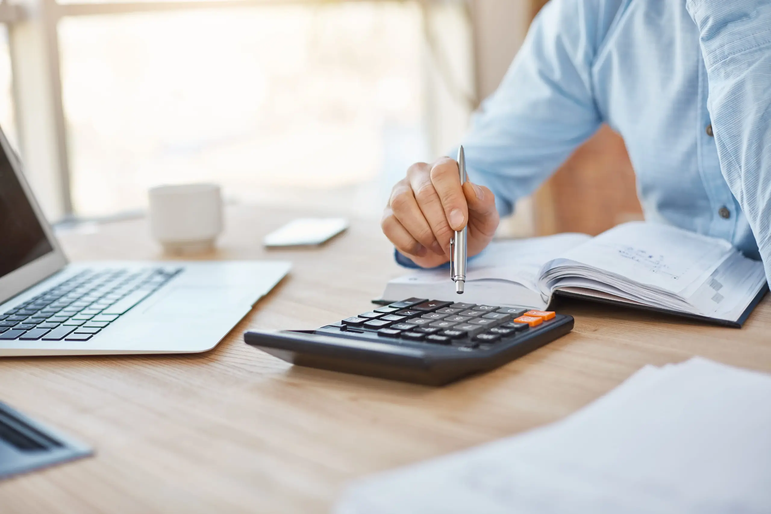 close up detail professional serious accountant sitting light office checking company finance profits calculator (1)