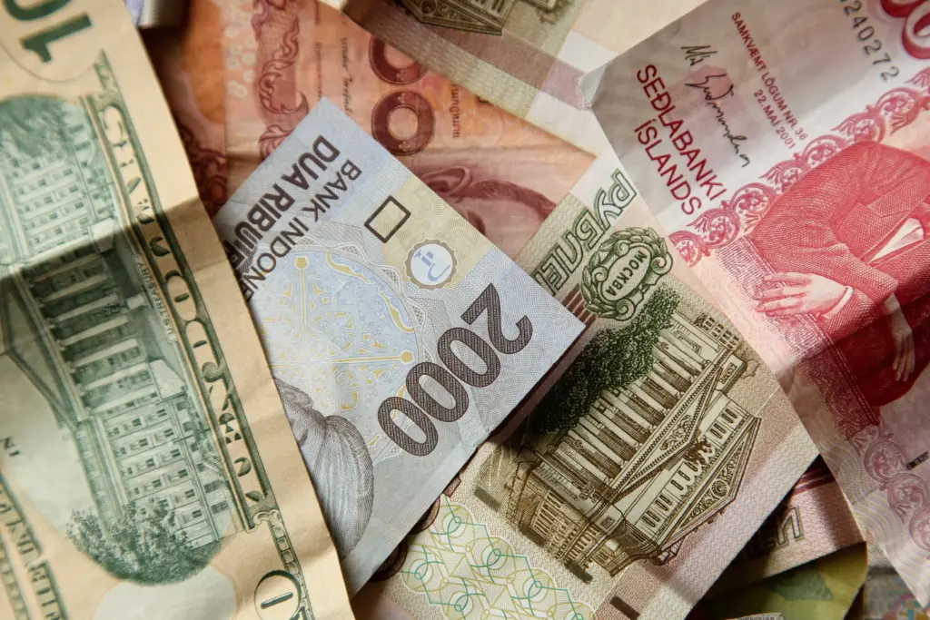high angle closeup shot pile banknotes wooden surface (1)