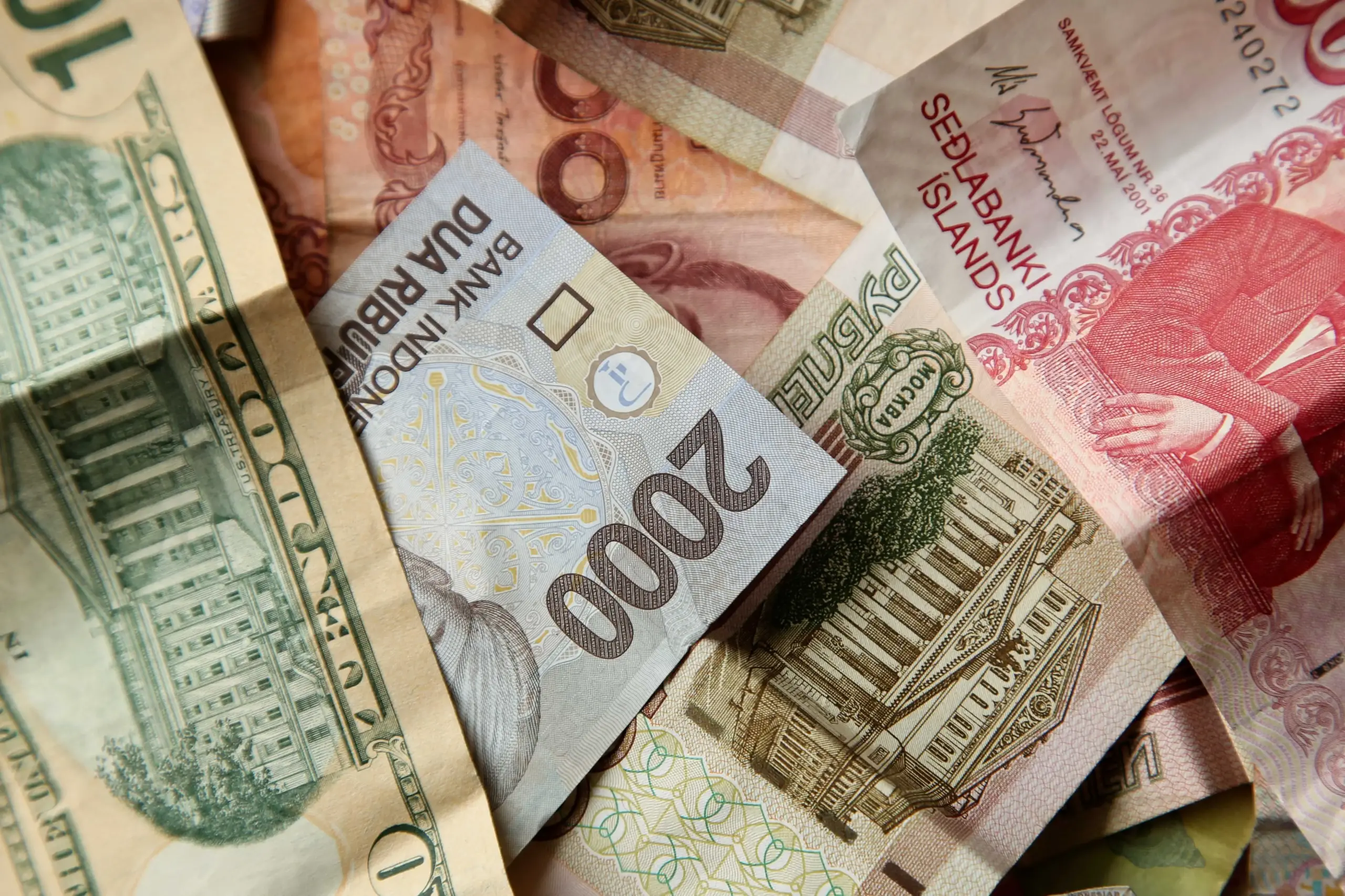 high angle closeup shot pile banknotes wooden surface (1)