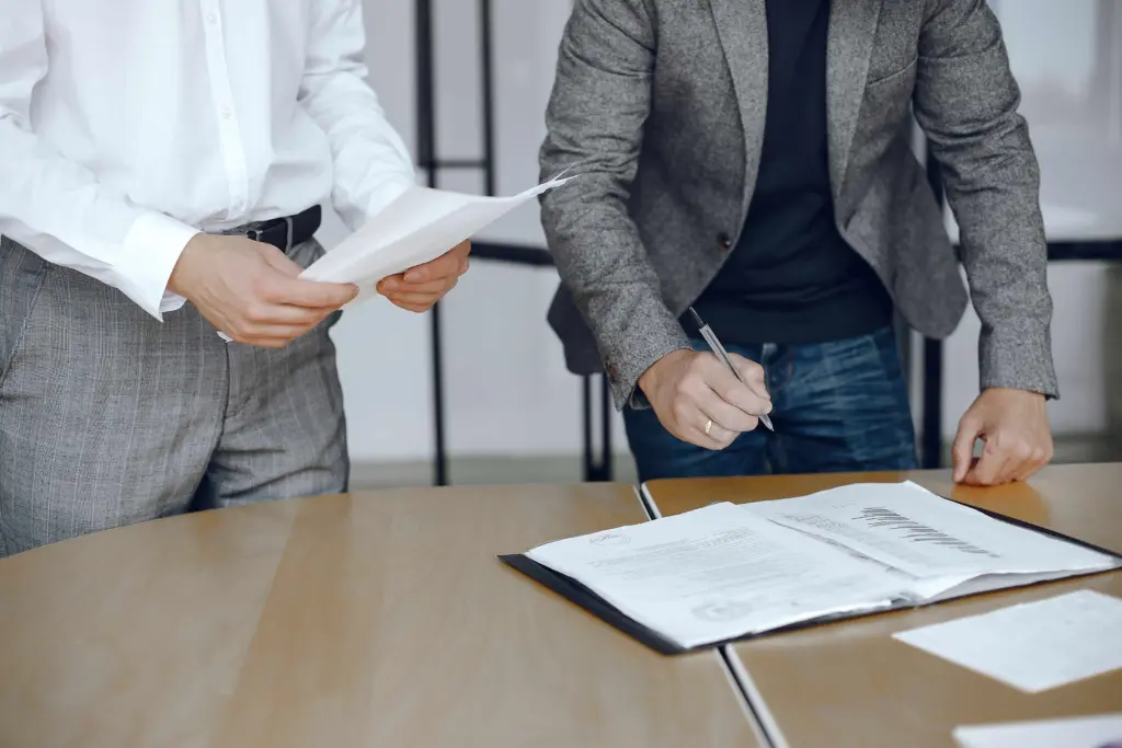 business men sitting lawyers s desk people signing important documents (1)