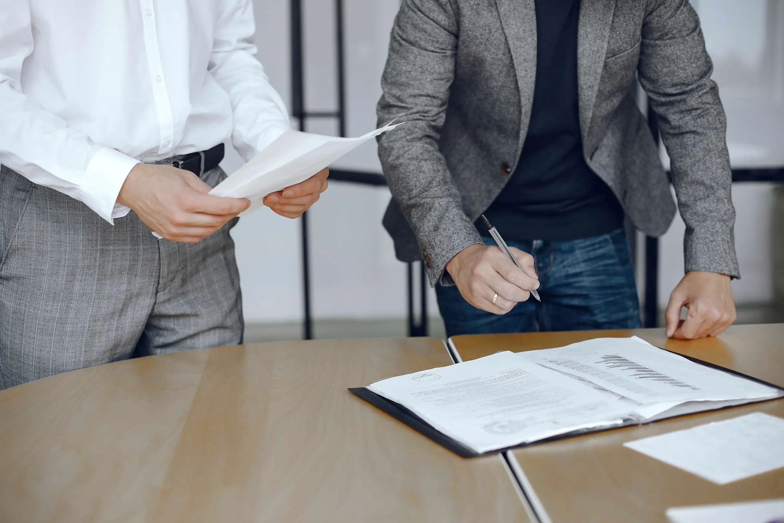 business men sitting lawyers s desk people signing important documents (1)