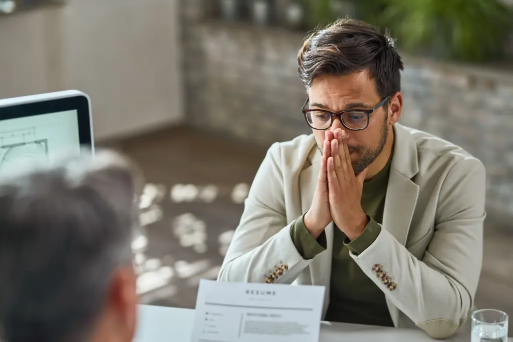 distraught young man feeling uncertain while having job interview office (1)