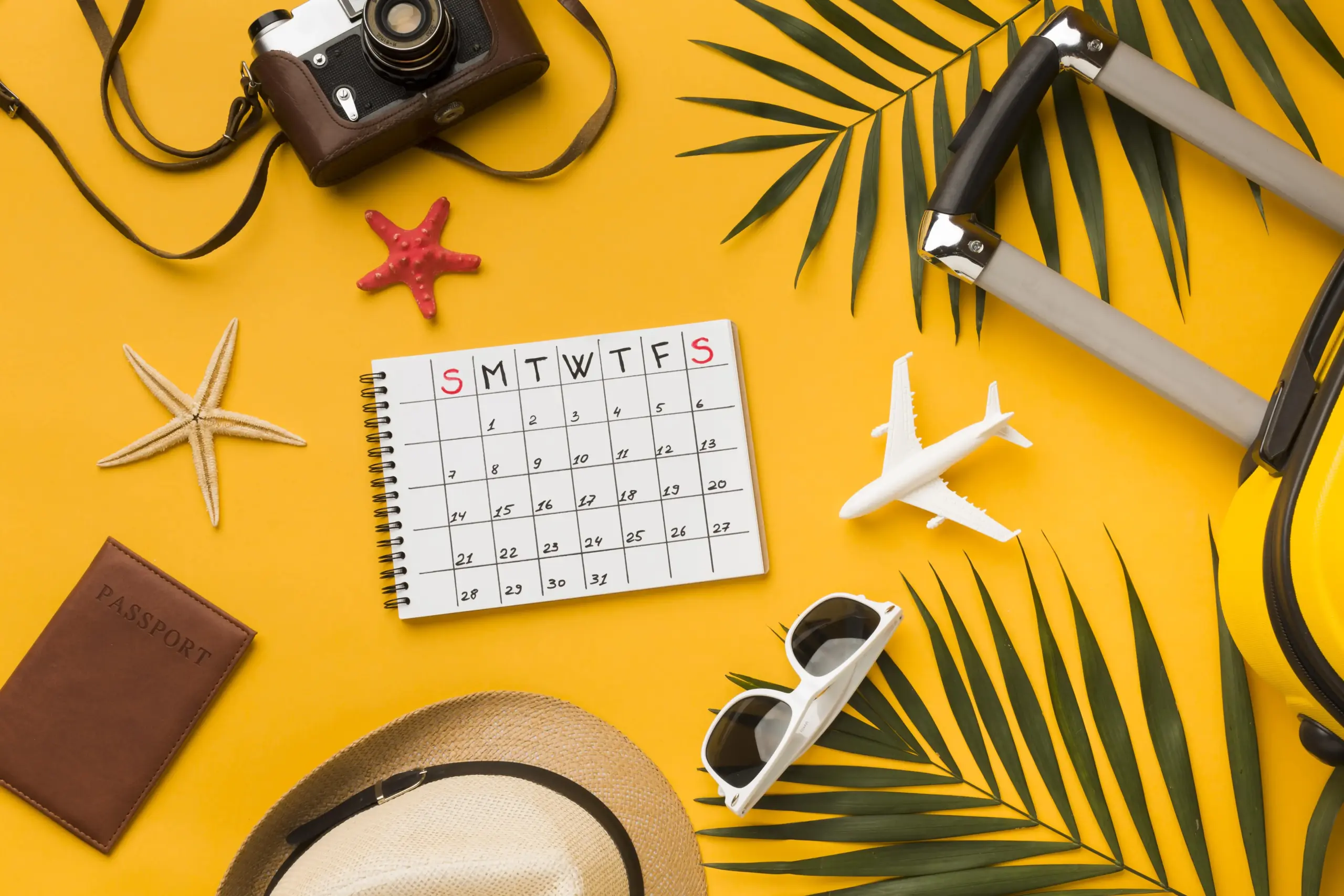 flat lay travel essentials with calendar sunglasses (1)